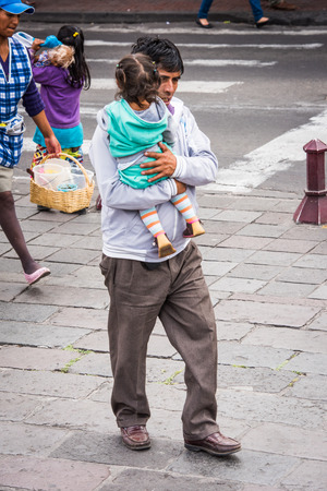 QUITO, ECUADOR - JAN 2, 2015: Unidentified Ecuadorian man and her little daughter. 71,9% of Ecuadorian people belong to the Mestizo ethnic groupのeditorial素材