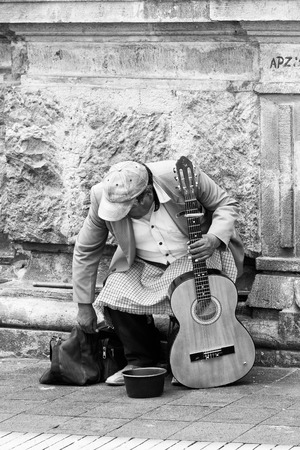 QUITO, ECUADOR - JAN 1, 2015: Unidentified Ecuadorian local musician play guitar in the street. 71,9% of Ecuadorian people belong to the Mestizo ethnic groupのeditorial素材