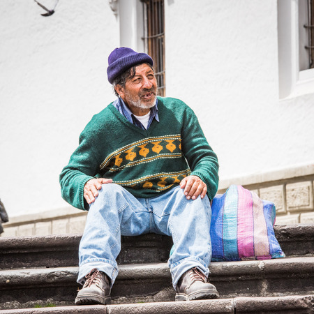 QUITO, ECUADOR - JAN 2, 2015: Unidentified Ecuadorian man with a bag on the stairs. 71,9% of Ecuadorian people belong to the Mestizo ethnic groupのeditorial素材