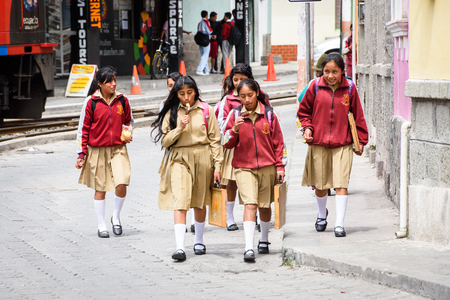 RIOBAMBA, ECUADOR - JAN 7, 2015: Unidentified Ecuadorian school girls walk in the street. 71,9% of Ecuadorian people belong to the Mestizo ethnic groupのeditorial素材