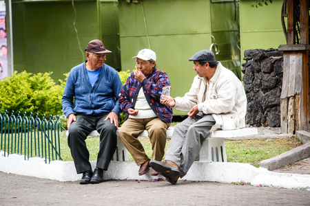 RIOBAMBA, ECUADOR - JAN 7, 2015: Unidentified Ecuadorian men and woman on a bench. 71,9% of Ecuadorian people belong to the Mestizo ethnic groupのeditorial素材