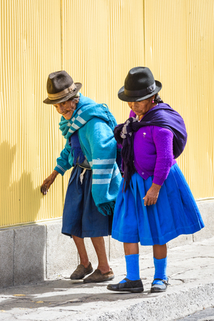 RIOBAMBA, ECUADOR - JAN 9, 2015: Unidentified Ecuadorian women in traditional clothes walks in the street. 71,9% of Ecuadorian people belong to the Mestizo ethnic groupのeditorial素材