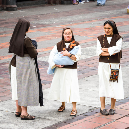RIOBAMBA, ECUADOR - JAN 7, 2015: Unidentified Ecuadorian monks with a baby. 71,9% of Ecuadorian people belong to the Mestizo ethnic groupのeditorial素材