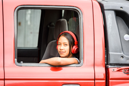 CUENCA, ECUADOR - JAN 9, 2015: Unidentified Ecuadorian girl smiles from the car. 71,9% of Ecuadorian people belong to the Mestizo ethnic groupのeditorial素材