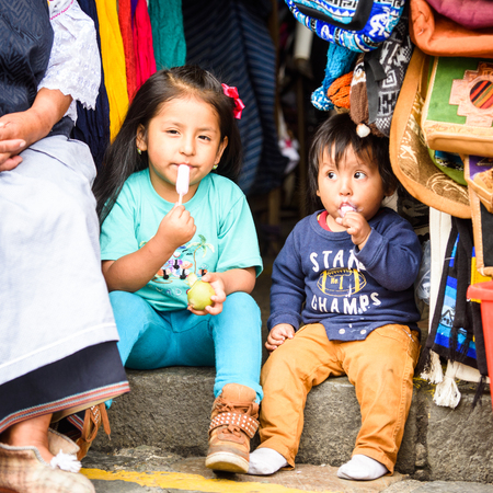 CUENCA, ECUADOR - JAN 9, 2015: Unidentified Ecuadorian children sit at the market. 71,9% of Ecuadorian people belong to the Mestizo ethnic groupのeditorial素材