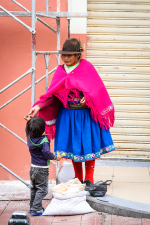CUENCA, ECUADOR - JAN 9, 2015: Unidentified Ecuadorian woman in traditional clothes in the street. 71,9% of Ecuadorian people belong to the Mestizo ethnic groupのeditorial素材