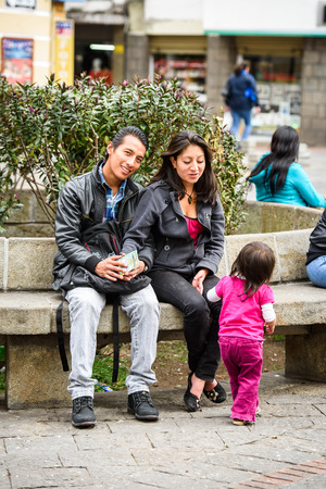 CUENCA, ECUADOR - JAN 9, 2015: Unidentified Ecuadorian girl and her parents. 71,9% of Ecuadorian people belong to the Mestizo ethnic groupのeditorial素材