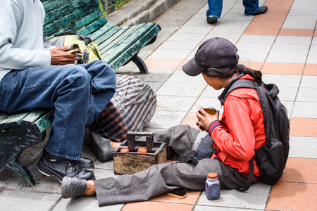 CUENCA, ECUADOR - JAN 9, 2015: Unidentified Ecuadorian children on a bench. 71,9% of Ecuadorian people belong to the Mestizo ethnic groupのeditorial素材