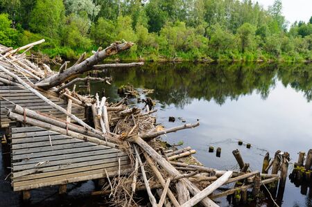 Part of a broken bridge over the riverの写真素材