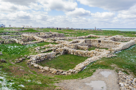 Ruins on the grass with snow of the Chersonesus (Crimea), Ukraine, bank of the Black Sea.