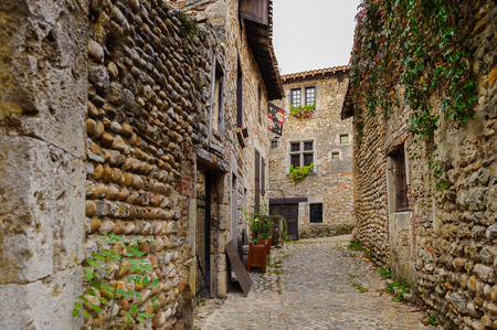 Narrow street in  Perouges, France, a medieval walled town, a popular touristic attraction.