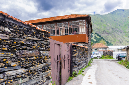 House in the field and mountainsの写真素材