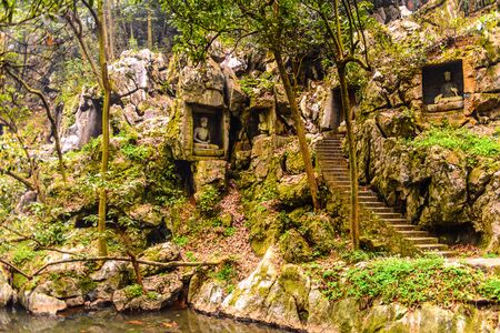 Rock reliefs at Feilai Feng at the Lingyin Temple (Temple of the Soul's Retreat) complex. One of the largest Buddhist temples in Chinaの写真素材