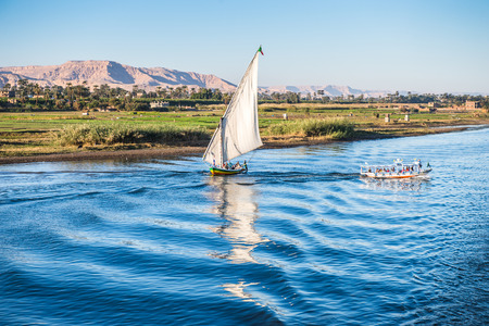 LUXOR, EGYPT - NOV 30, 2014: Coastline of the river NIle near Luxor. Nile is 6,853 km long. The Nile is an "international" river shared by eleven countriesのeditorial素材