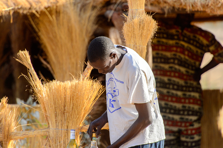 FERLO DESERT, SENEGAL - APR 25, 2017: Unidentified Fulani man tries to open the bottle . Fulanis (Peul) are the largest tribe in West African savannahsのeditorial素材