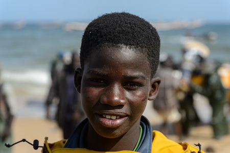 KAYAR, SENEGAL - APR 27, 2017: Unidentified Senegalese little boy smiles on the coast of the Atlantic Ocean. Many Kayar people work in portのeditorial素材