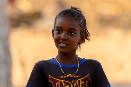 FERLO DESERT, SENEGAL - APR 25, 2017: Unidentified Fulani little girl smiles. Fulanis (Peul) are the largest tribe in West African savannahsのeditorial素材