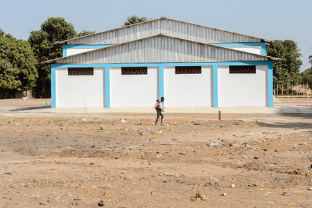 ZIGUINCHOR, SENEGAL - APR 28, 2017: Unidentified Senegalese woman carries a baby on her back. Still many people in Senegal live in povertyのeditorial素材
