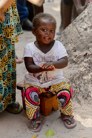 KASCHOUANE, SENEGAL - APR 29, 2017: Unidentified Diola little girl with braids sits in Kaschouane village. Diolas are the ethnic group predominate in the region of Casamanceのeditorial素材
