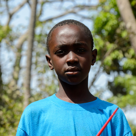 KASCHOUANE, SENEGAL - APR 29, 2017: Unidentified Diola little boy in blue shirt stands in Kaschouane village. Diolas are the ethnic group predominate in the region of Casamanceのeditorial素材