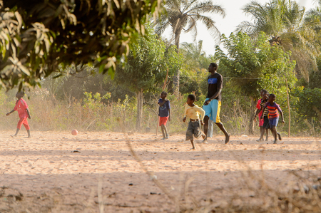 ZIGUINCHOR, SENEGAL - APR 28, 2017: Unidentified Senegalese children play football on the street. Still many people in Senegal live in povertyのeditorial素材
