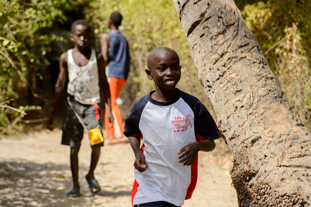 KASCHOUANE, SENEGAL - APR 29, 2017: Unidentified Diola little boy runs along the street in Kaschouane village. Diolas are the ethnic group predominate in the region of Casamanceのeditorial素材