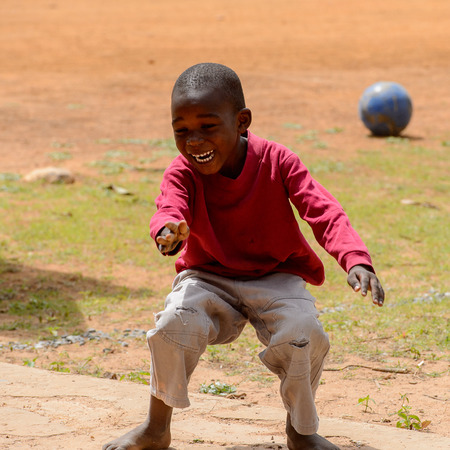 DAKAR, SENEGAL - APR 27, 2017: Unidentified Senegalese little boy in red shirt smiles in the Village des Arts in Dakarのeditorial素材