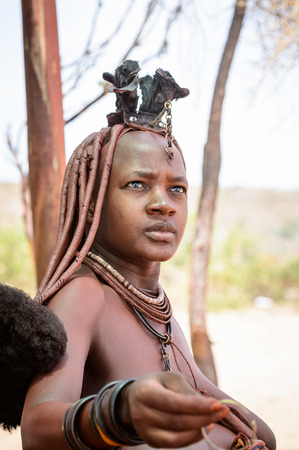 KAMANJAB, NAMIBIA - SEPTEMBER 07, 2015: Unidentified woman from Himba tribe. The Himba are...