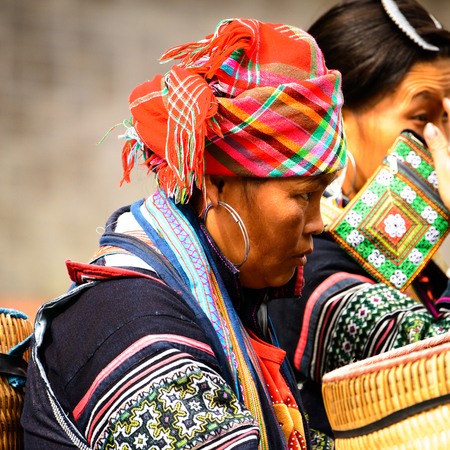 SAPA, VIETNAM - SEP 20, 2014: Unidentified Hmong woman wearing the traditional costume to attract the tourists and red kerchief . Hmong people is a minority ethnic group living in Sapaのeditorial素材