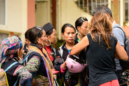 SAPA, VIETNAM - SEP 20, 2014: Unidentified Hmong women wearing the traditional costume to attract the tourists. Hmong people is a minority ethnic group living in Sapaのeditorial素材