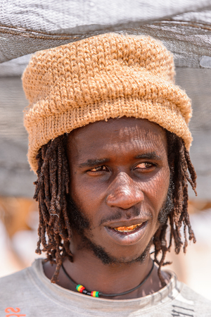 WINDHOEK, NAMIBIA - JAN 3, 2016: Unidentified Ovambo man in a hat in Namibia.  Ovambo is the most popular ethnic groupのeditorial素材