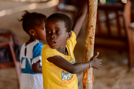 KASCHOUANE, SENEGAL - APR 29, 2017: Unidentified Diola little girl with braids walks from behind in Kaschouane village. Diolas are the ethnic group predominate in the region of Casamanceのeditorial素材
