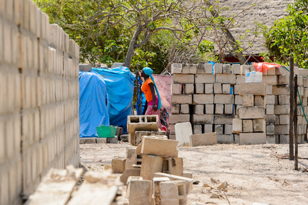 KASCHOUANE, SENEGAL - APR 29, 2017: Unidentified Diola woman walks along the street in Kaschouane village. Diolas are the ethnic group predominate in the region of Casamanceのeditorial素材