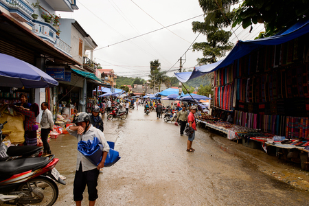 BAC HA, VIETNAM - SEP 21, 2014: Tents of the Bac Ha Market, a large Sunday market with people wearing beautiful colored minorities costumesのeditorial素材