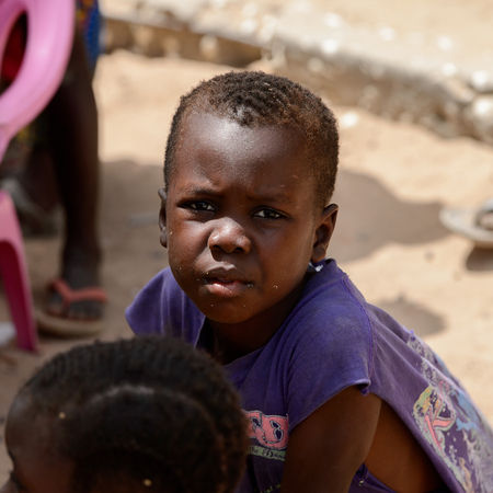 ORANGO ISLAND, GUINEA BISSAU - MAY 3, 2017: Unidentified local little boy looks ahead in the Etigoca village. People in G.-Bissau still suffer of povertyのeditorial素材