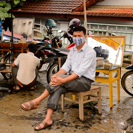 BAC HA, VIETNAM - SEP 21, 2014: Unidentified man sells  at the Bac Ha Market, a large Sunday market with people wearing beautiful colored minorities costumesのeditorial素材