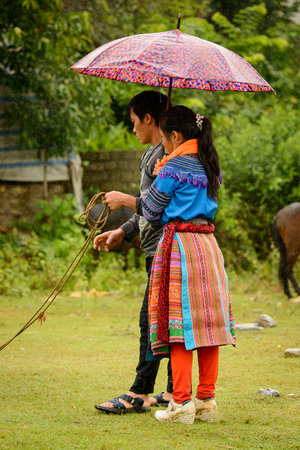 BAC HA, VIETNAM - SEP 21, 2014: Unidentified Vietnamese woman in a traditional ethnic minorities' dress at the Bac Ha Market, a large Sunday market with people wearing beautiful colored minoritiesâ costumesのeditorial素材