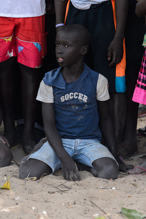 ORANGO ISLAND, GUINEA BISSAU - MAY 3, 2017: Unidentified local little boy sits on the ground in the Etigoca village. People in G.-Bissau still suffer of povertyのeditorial素材