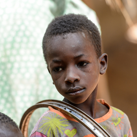 CANHABAQUE, GUINEA BISSAU - MAY 4, 2017: Unidentified local little boy looks away in a village of the Canhabaque island. People in G.-Bissau still suffer of povertyのeditorial素材