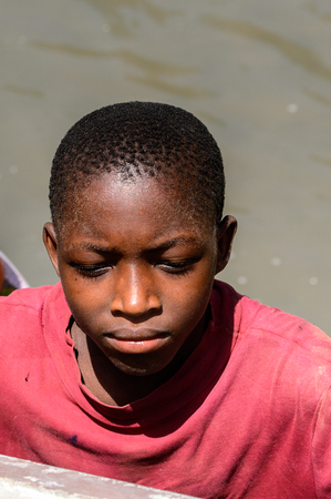 CANHABAQUE, GUINEA BISSAU - MAY 4, 2017: Unidentified local little boy looks ahead in a village of the Canhabaque island. People in G.-Bissau still suffer of povertyのeditorial素材
