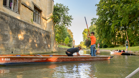 CAMBRIDGE, ENGLAND - JULY 19, 2016: Unidentified man sails in a boat over the river Cam, Cambridge, England. The original name was the Granta riverのeditorial素材