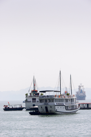 HA LONG CITY, VIETNAM - SEP 23, 2014: Touristoc Boats near the port of the Halong city where many touristic boat start jorneys over the Halong bay which is UNESCO World heritageのeditorial素材