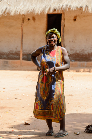 CANHABAQUE, GUINEA BISSAU - MAY 4, 2017: Unidentified local woman in headscarf walks along the street in a village of the Canhabaque island. People in G.-Bissau still suffer of povertyのeditorial素材