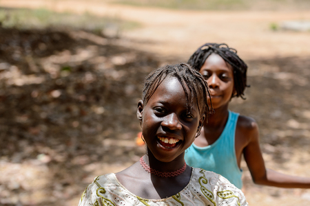 CANCHUNGO, GUINEA BISSAU - MAY 3, 2017: Unidentified local children with braids smile. Bissau-Guinean people suffer of poverty due to the bad economyのeditorial素材