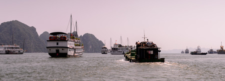 HA LONG CITY, VIETNAM - SEP 23, 2014: Touristoc Boats near the port of the Halong city where many touristic boats start jorneys over the Halong bay which is UNESCO World heritageのeditorial素材