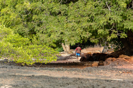 SOGA, GUINEA BISSAU - MAY 5, 2017: Unidentified local man walks along the street on the coast of the Soga island, part of the Bijagos Archipelagoのeditorial素材