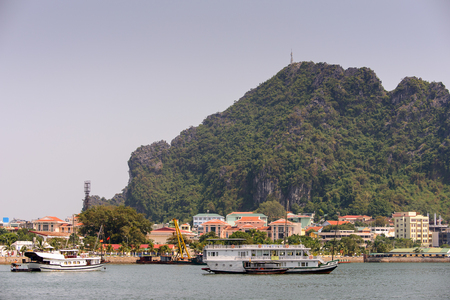 HA LONG CITY, VIETNAM - SEP 23, 2014: Touristoc Boats near the port of the Halong city where many touristic boats start jorneys over the Halong bay which is UNESCO World heritageのeditorial素材
