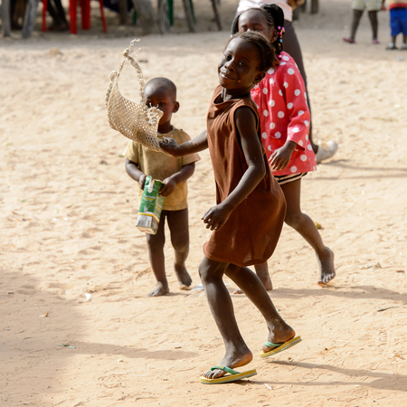 ORANGO ISLAND, GUINEA BISSAU - MAY 3, 2017: Unidentified local children play in the Etigoca village. People in G.-Bissau suffer of poverty due to the bad economyのeditorial素材