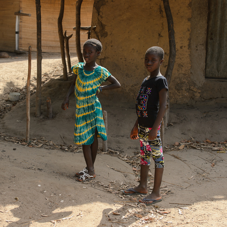 CANHABAQUE, GUINEA BISSAU - MAY 4, 2017: Unidentified local little girl stands in a village of the Canhabaque island. People in G.-Bissau still suffer of povertyのeditorial素材
