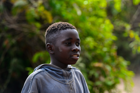 SOGA, GUINEA BISSAU - MAY 5, 2017: Unidentified local little boy stands in a village of the Soga island. People in G.-Bissau still suffer of povertyのeditorial素材